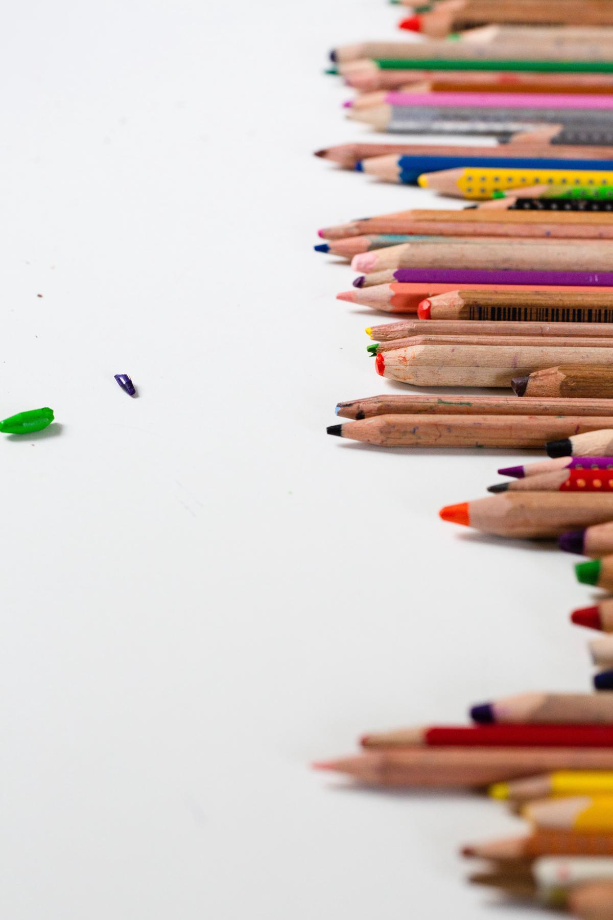 Illustration of a child drawing with colorful crayons