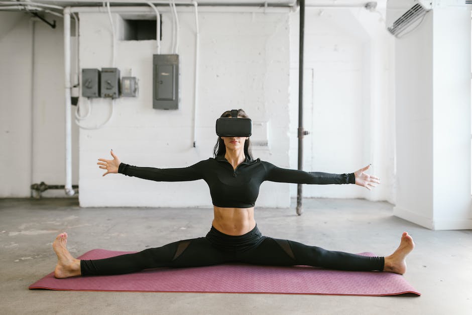 A woman doing a virtual reality workout with a fitness headset.