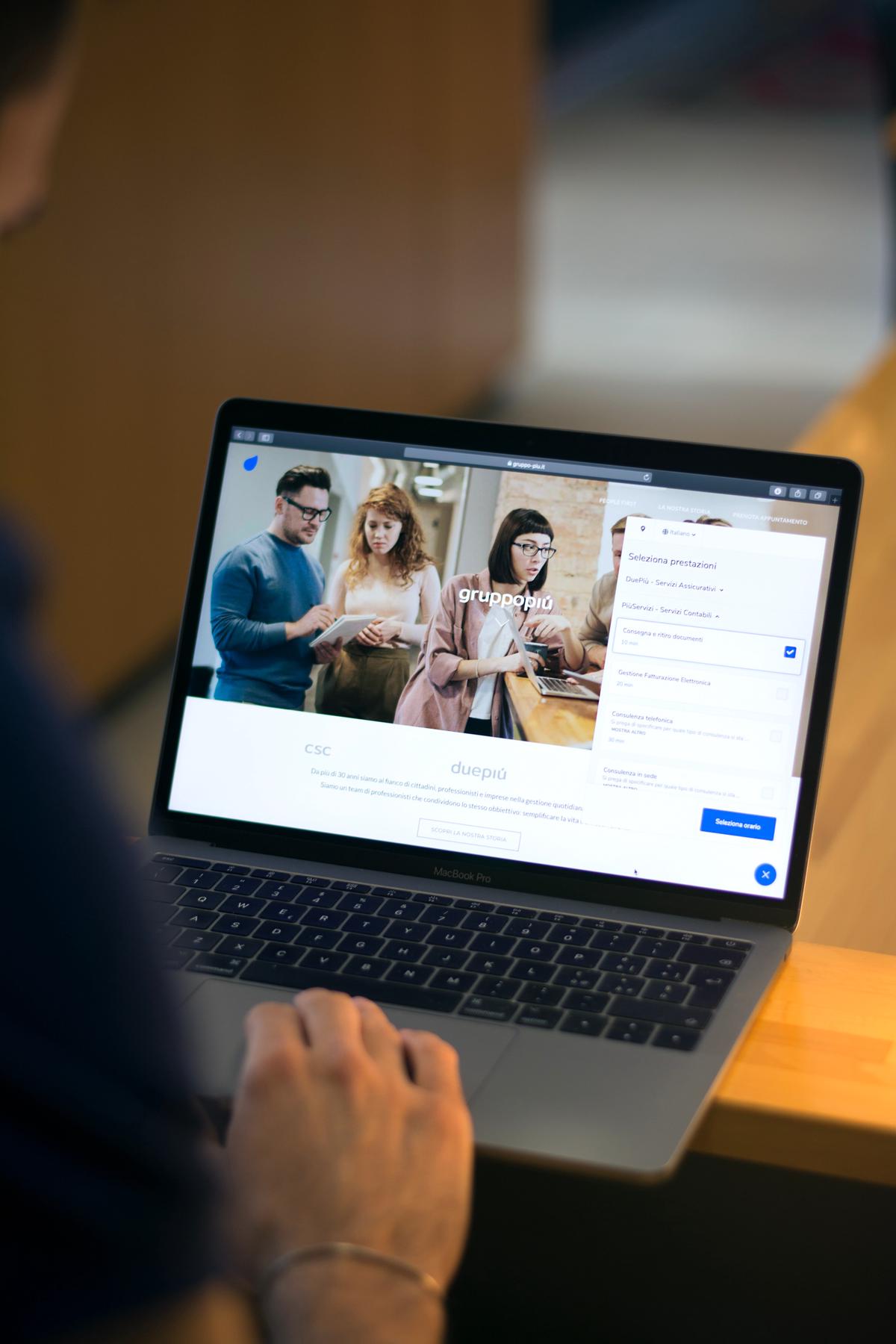 A computer screen displaying parental controls on Google Chrome, with a child sitting next to it with a parent supervising.