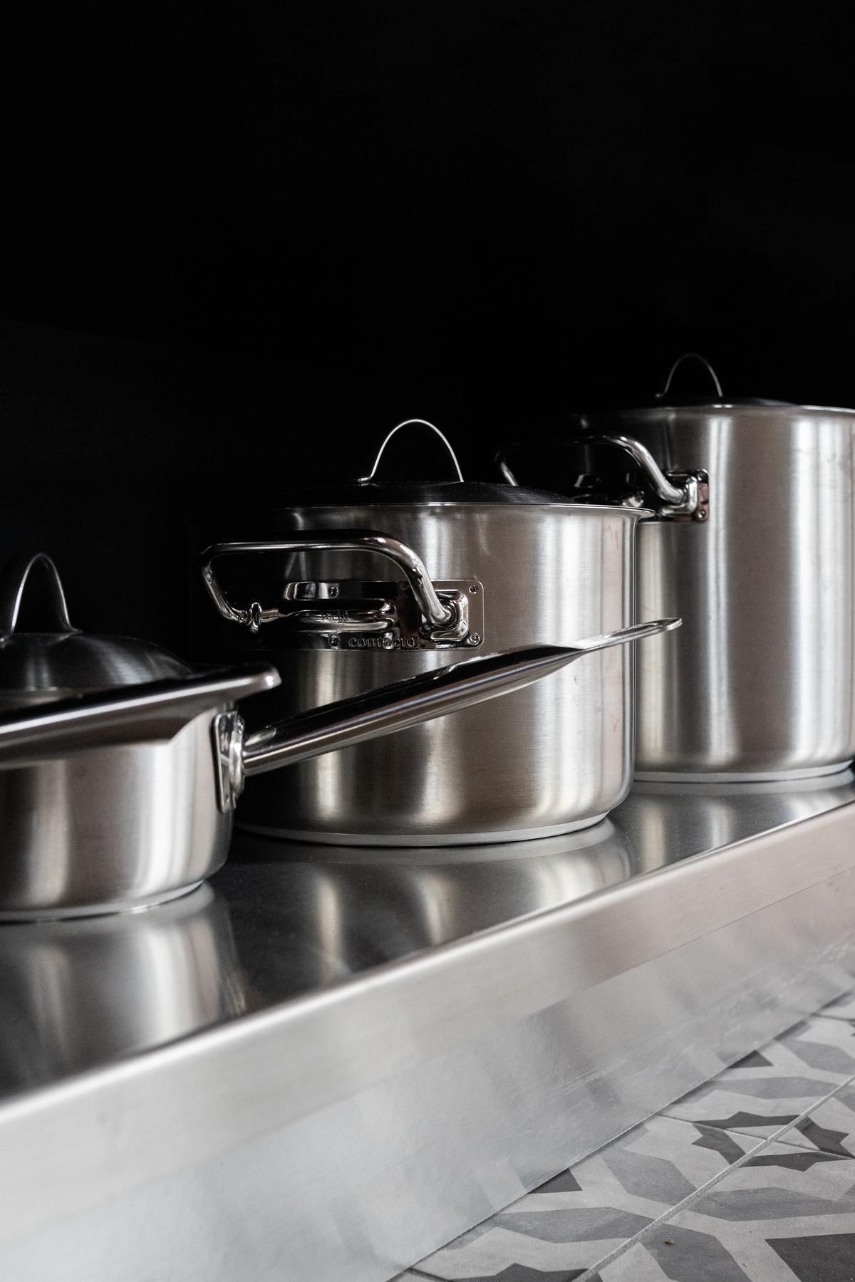 A person using a pressure cooker in the kitchen, showcasing the advantages of speed, energy savings, and healthier meals.